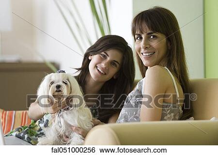Mother and teenage daughter with pet dog, portrait View Large Photo Image Stock Photograph - Mother and teenage daughter with pet dog, portrait. Fotosearch