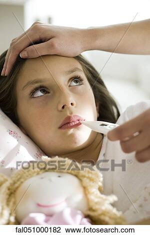 Mother checking daughter's temperature, caressing forehead, cropped View Large Photo Image Stock Image - Mother checking daughter's temperature, caressing forehead, cropped. Fotosearch