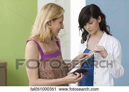 Mother giving teenage daughter pocket money View Large Photo Image Stock Image - Mother giving teenage daughter pocket money. Fotosearch
