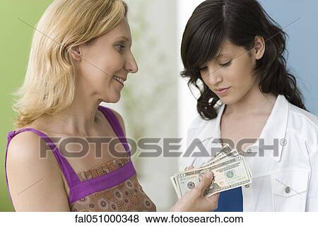 Mother giving teenage daughter pocket money View Large Photo Image Stock Photo - Mother giving teenage daughter pocket money. Fotosearch
