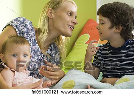 Mother relaxing with young son and infant daughter View Large Photo Image Stock Image - Mother relaxing with young son and infant daughter. Fotosearch