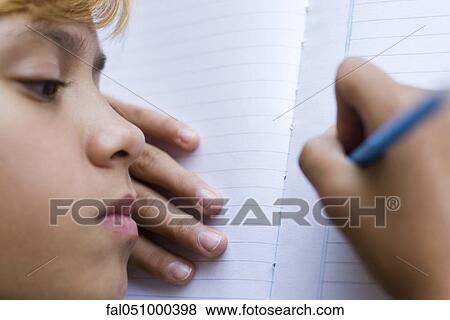 Stock Photo - Preteen girl writing in notebook. Fotosearch