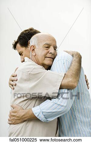 Senior man embracing adult son View Large Photo Image Stock Photography - Senior man embracing adult son. Fotosearch