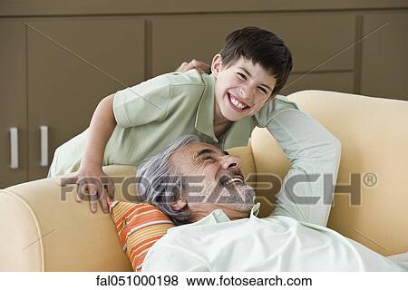 Senior man relaxing, enjoying time with young grandson View Large Photo Image Stock Photo - Senior man relaxing, enjoying time with young grandson. Fotosearch