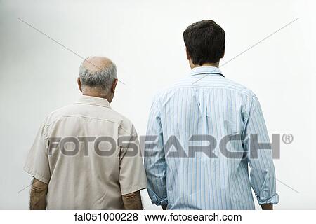 Senior man walking with adult son, rear view View Large Photo Image Stock Photo - Senior man walking with adult son, rear view. Fotosearch