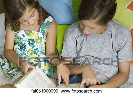 Siblings reading together View Large Photo Image Stock Image - Siblings reading together. Fotosearch