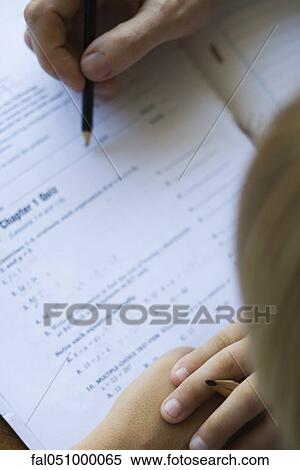 Student watching as teacher corrects quiz, close-up View Large Photo Image Stock Photography - Student watching as teacher corrects quiz, close-up. Fotosearch
