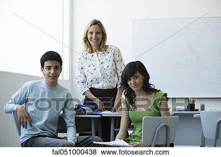 Stock Photo - Teacher and high school students together in classroom, portrait. Fotosearch