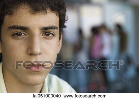 Teenage book with pensive expression looking at camera View Large Photo Image Stock Image - Teenage book with pensive expression looking at camera. Fotosearch