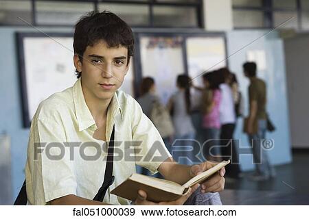 Teenage boy reading book View Large Photo Image Stock Photo - Teenage boy reading book. Fotosearch