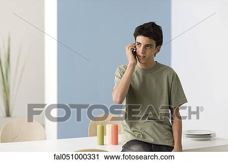 Teenage boy using cell phone View Large Photo Image Stock Image - Teenage boy using cell phone. Fotosearch