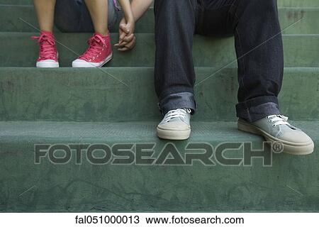 Teenage couple sitting together on steps, low section View Large Photo Image Stock Image - Teenage couple sitting together on steps, low section. Fotosearch