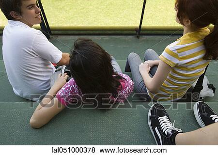 Stock Photo - Teenage friends hanging out together. Fotosearch