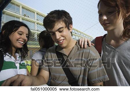 Teenage friends laughing together View Large Photo Image Stock Photography - Teenage friends laughing together. Fotosearch