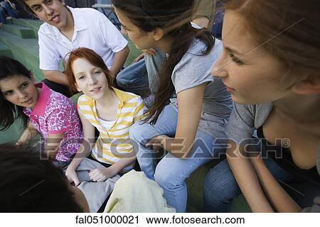 Teenage girl hanging out with group of friends View Large Photo Image Stock Image - Teenage girl hanging out with group of friends. Fotosearch
