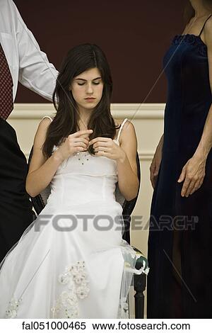 Teenage girl in formal gown bored at formal social event View Large Photo Image Stock Photography - Teenage girl in formal gown bored at formal social event. Fotosearch