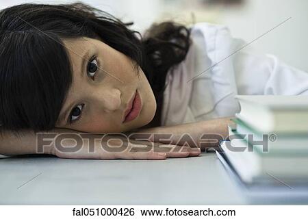 Stock Photograph - Teenage girl taking break from studies. Fotosearch