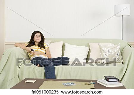 Teenage girl with remote control contemplatively looking away View Large Photo Image Stock Photography - Teenage girl with remote control contemplatively looking away. Fotosearch