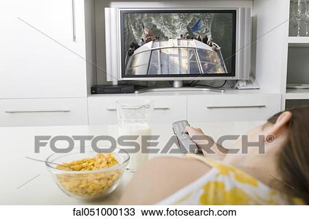 Watching television while having breakfast View Large Photo Image Stock Image - Watching television while having breakfast. Fotosearch