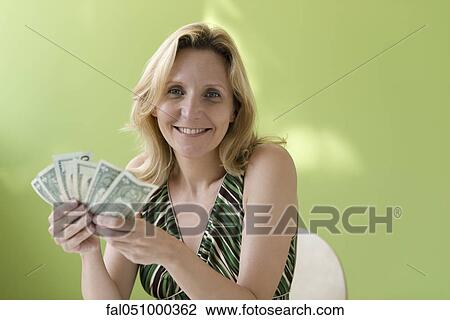 Woman holding handful of cash View Large Photo Image Stock Image - Woman holding handful of cash. Fotosearch