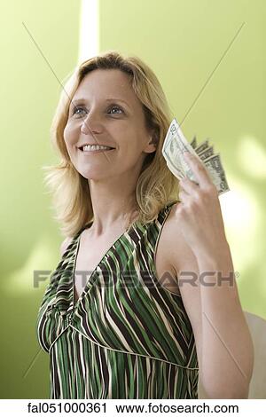 Woman holding up handful of cash View Large Photo Image Stock Image - Woman holding up handful of cash. Fotosearch