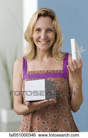 Woman opening gift, portrait View Large Photo Image Stock Photograph - Woman opening gift, portrait. Fotosearch