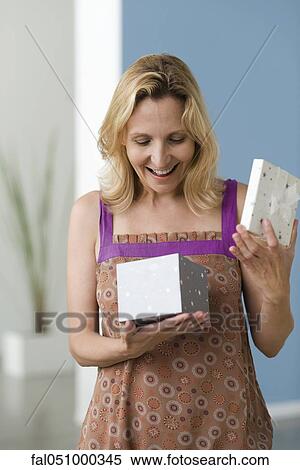 Woman opening gift View Large Photo Image Stock Photography - Woman opening gift. Fotosearch