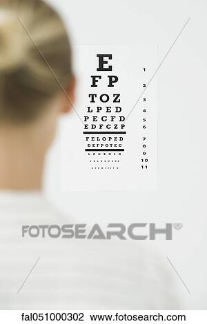 Stock Image - Woman taking eye exam. Fotosearch