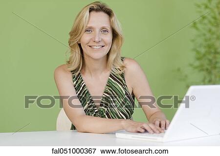 Woman using laptop computer, portrait View Large Photo Image Stock Photo - Woman using laptop computer, portrait. Fotosearch