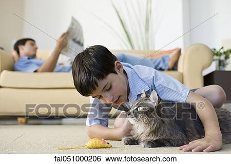 Stock Photograph - Young boy with pet cat. Fotosearch