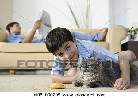 Young boy with pet cat View Large Photo Image Stock Photography - Young boy with pet cat. Fotosearch
