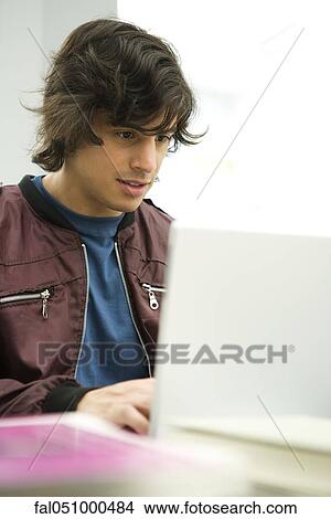 Young man using laptop View Large Photo Image Picture - Young man using laptop. Fotosearch