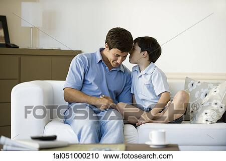 Young son whispering secret to father View Large Photo Image Stock Image - Young son whispering secret to father. Fotosearch