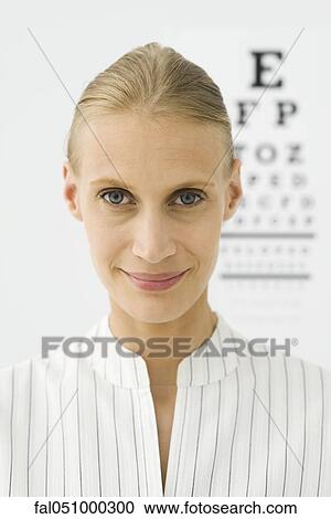 Young woman, eye chart in background, portrait View Large Photo Image Stock Image - Young woman, eye chart in background, portrait. Fotosearch