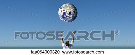 Arms raised reaching out to planet earth orbiting overhead View Large Photo Image Stock Image - Arms raised reaching out to planet earth orbiting overhead. Fotosearch