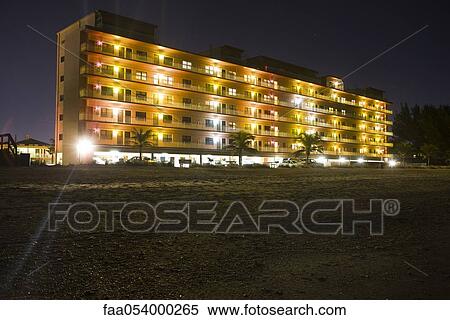 Stock Photography - Beachside hotel illuminated at night. Fotosearch
