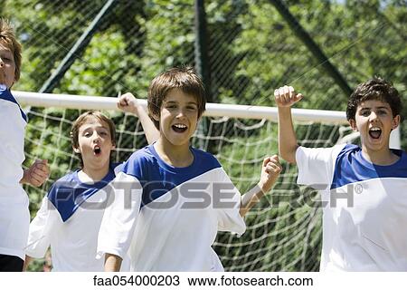 Boys on soccer field, fists raised in victory View Large Photo Image Stock Image - Boys on soccer field, fists raised in victory. Fotosearch