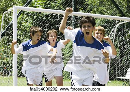Stock Image - Boys playing soccer. Fotosearch