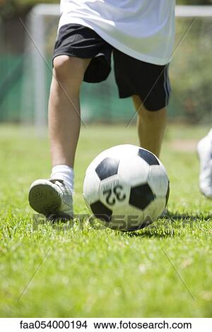Child playing soccer, cropped View Large Photo Image Picture - Child playing soccer, cropped. Fotosearch