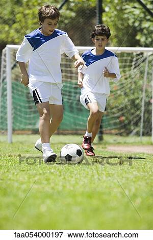 Children playing soccer, cropped View Large Photo Image Stock Photo - Children playing soccer, cropped. Fotosearch