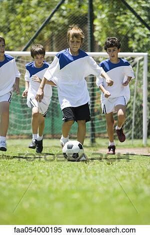 Children playing soccer, cropped View Large Photo Image Stock Photography - Children playing soccer, cropped. Fotosearch