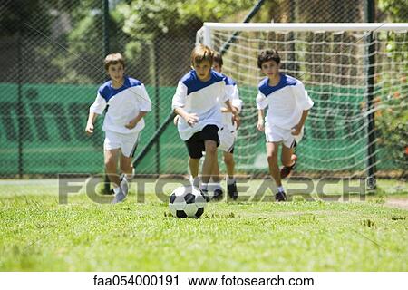 Stock Image - Children playing soccer. Fotosearch