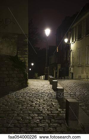 Stock Photograph - Cobblestone street at night. Fotosearch