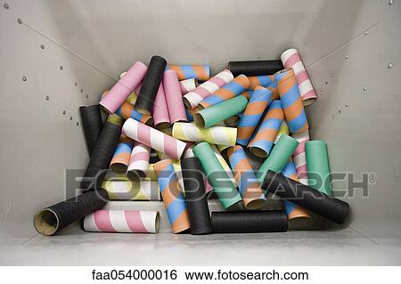 Stock Photograph - Empty bobbins in plastic container in weaving mill. Fotosearch