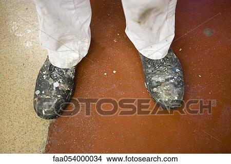 Picture - Fabric coating plant, machinist wearing safety boots. Fotosearch