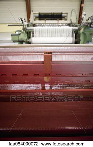 Stock Image - Fabric coating plant, recyclable composite textile weaving department, loom. Fotosearch