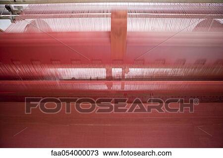 Stock Image - Fabric coating plant, recyclable composite textile weaving department, loom. Fotosearch