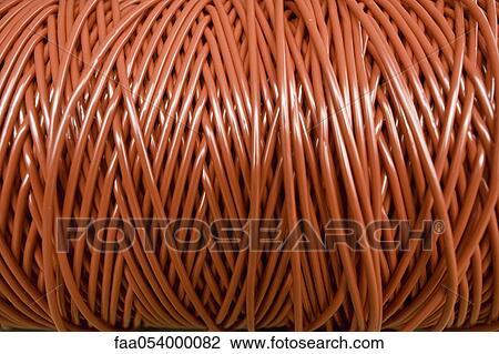 Stock Image - Fabric coating plant, recyclable composite textile weaving, close-up of reel of coated thread. Fotosearch