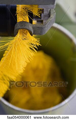 Stock Image - Fabric coating plant, weaving department, textile composite fabric selvage. Fotosearch