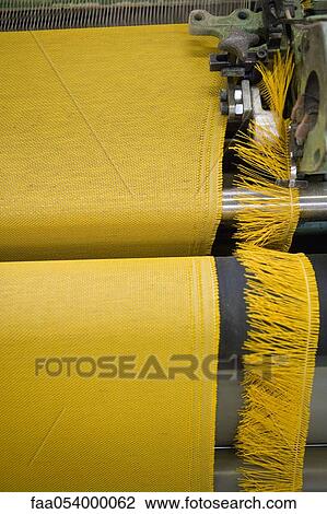 Stock Image - Fabric coating plant, weaving department, textile composite fabric selvage. Fotosearch